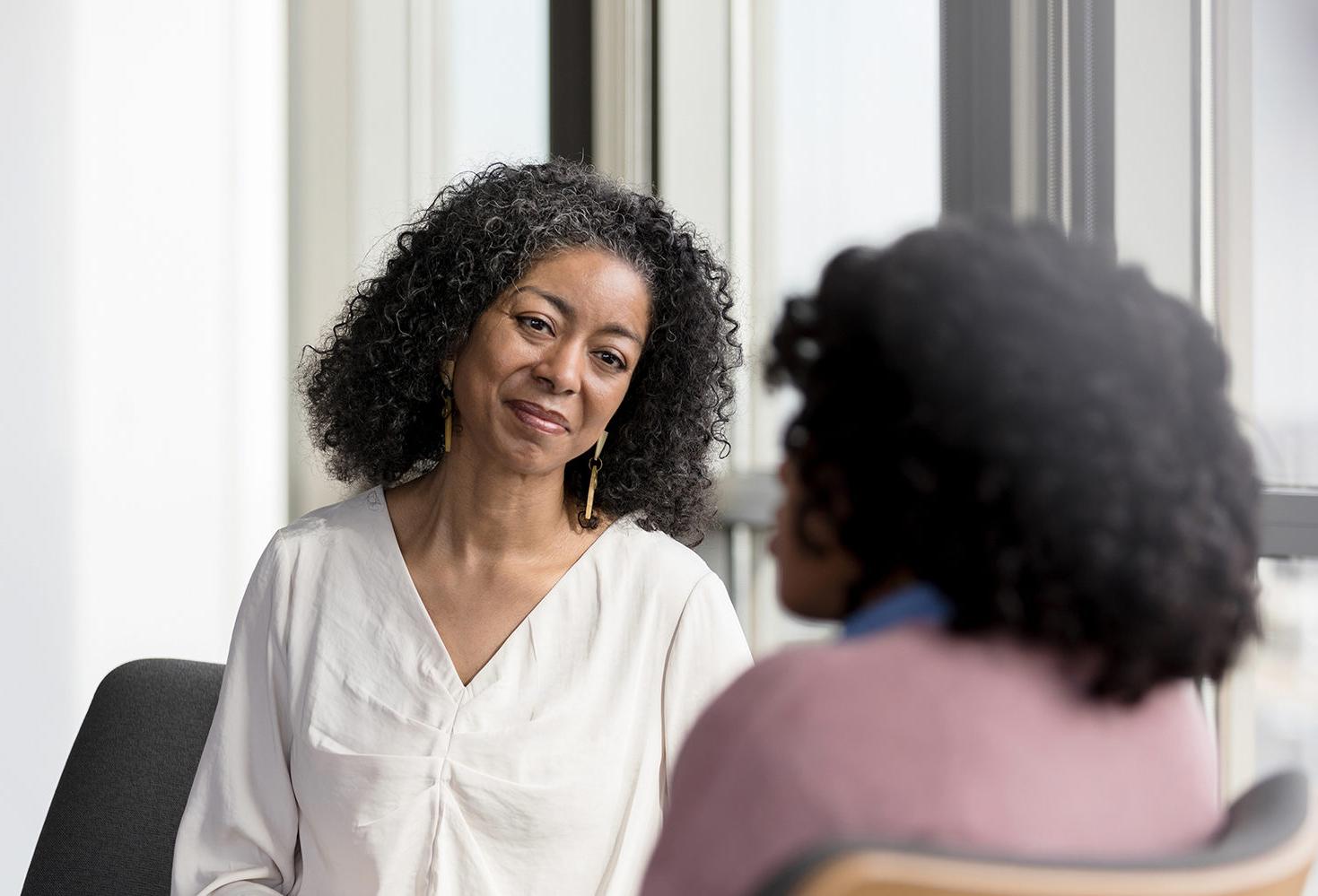 Woman working in healthcare looks an recognizable patient